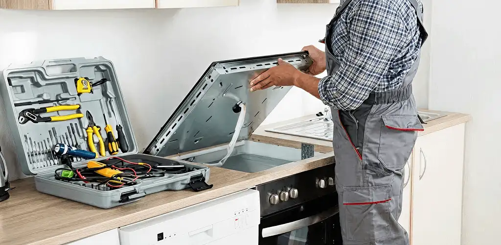 Handyman repairing a cooktop and checking wiring connections in Richmond, VA