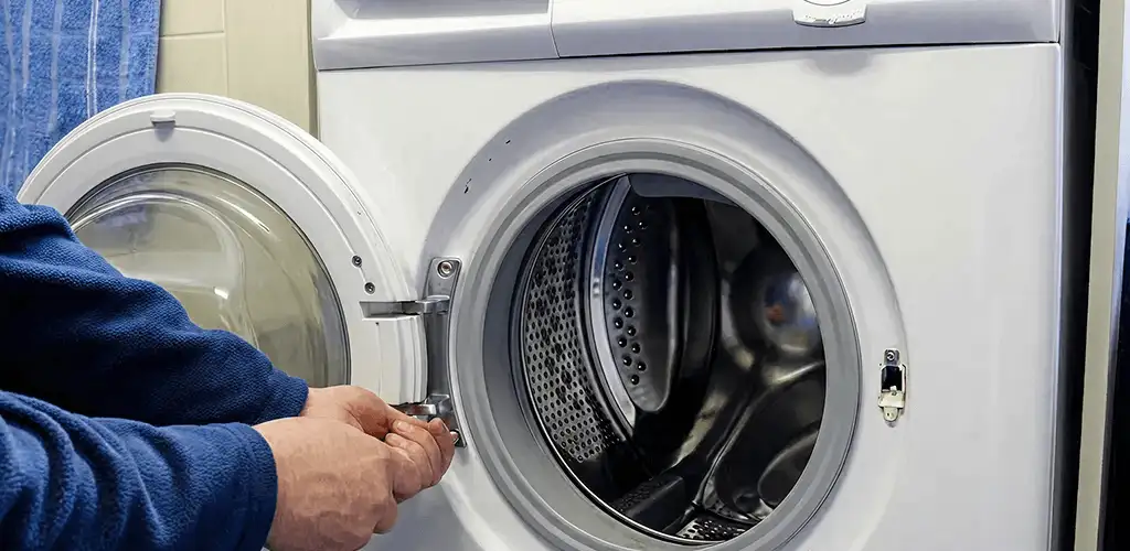 Washing machine repair handyman checking a front-load washer door and latch in Richmond, VA