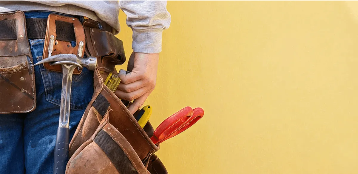 Handyman with tool belt ready for home repairs and maintenance in Richmond, VA