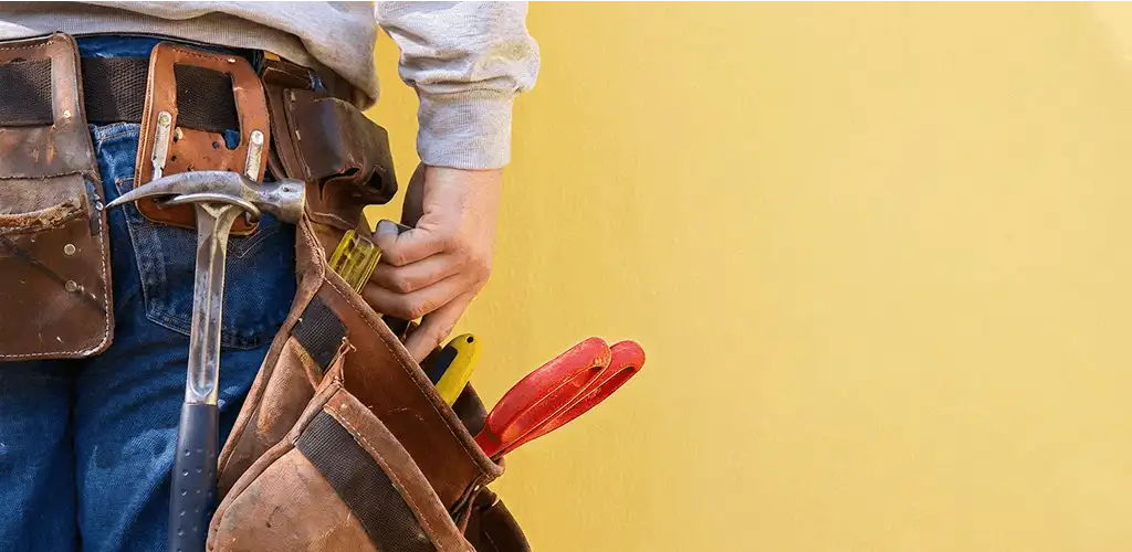 Handyman with tool belt ready for home repairs and maintenance in Richmond, VA