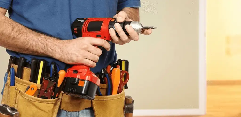 Handyman holding a power drill for home repairs and installations in Richmond, VA