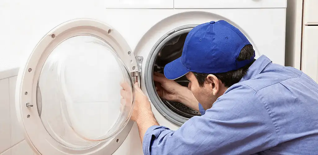 Washing machine repair handyman inspecting a front-load washer drum in Richmond, VA