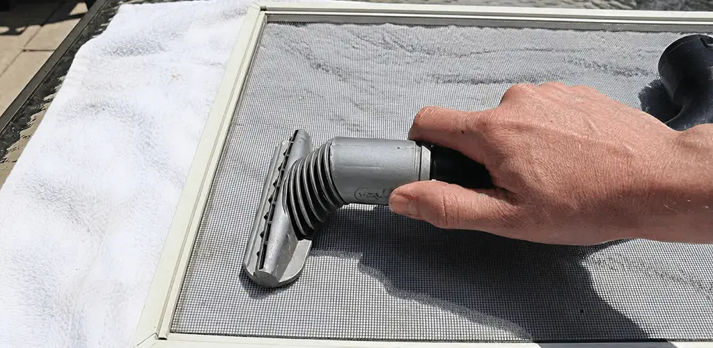 Window screen repair cleaning and fixing a damaged screen mesh in Richmond, VA